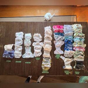 Lot of 14 reusable Cloth Diapers and 30 covers, basically new! (Fits 6-35 lbs)